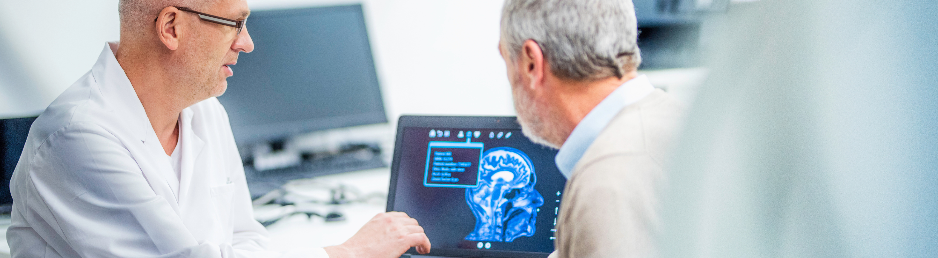 Older adult getting his lab results checked by a doctor